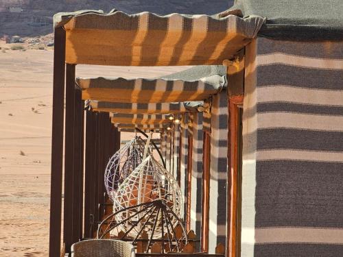 a room with a striped curtain and a table at Camp sami in Disah