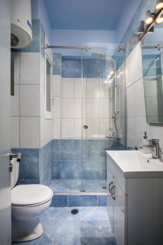a bathroom with a shower and a toilet and a sink at Corfu City Center Design Residence incl private parking in Corfu