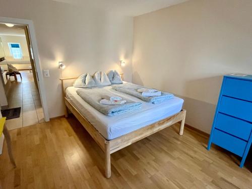 a bedroom with a bed with towels on it at Apartments Aarbergergasse - Self Check-In in Bern