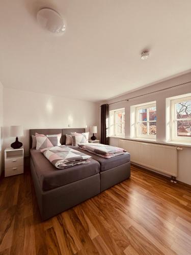 a large bedroom with two beds and wooden floors at Domplatz Suite in Erfurt