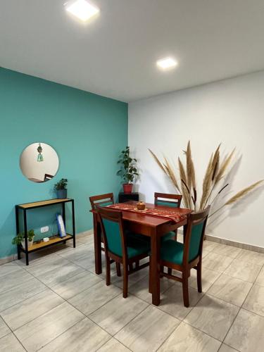 a dining room with a wooden table and chairs at Cabana Alojamiento Turistico in Humahuaca
