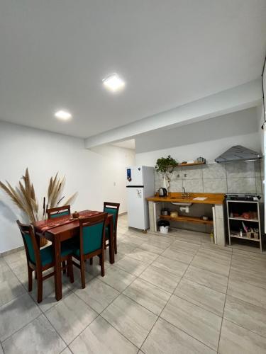 a kitchen and dining room with a table and chairs at Cabana Alojamiento Turistico in Humahuaca