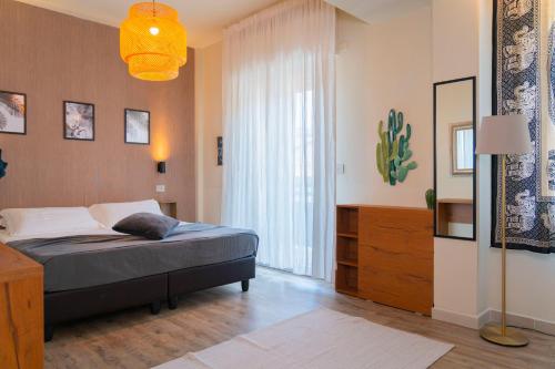 a bedroom with a bed and a large window at Hotel Rex - Lifestyle in Gabicce Mare