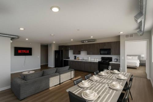 a living room with a dining table and a kitchen at Axis Suite in Des Moines