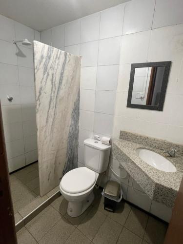 a bathroom with a toilet and a sink at Pousada Casa Bali in Fortaleza