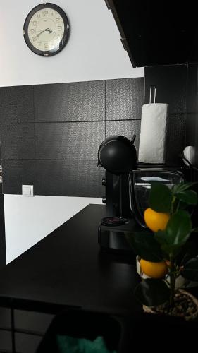 a desk with a chair and a clock on the wall at SCC2 Apartments in Cluj-Napoca