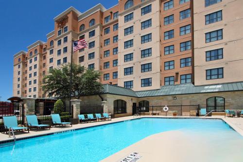 a swimming pool in front of a hotel at Residence Inn DFW Airport North/Grapevine in Grapevine