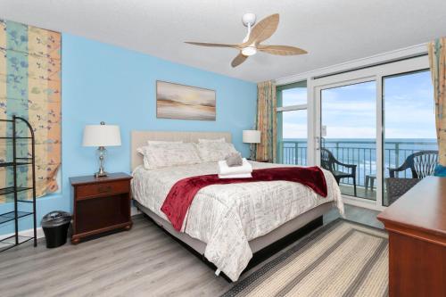 a bedroom with a bed with a view of the ocean at Amazing Oceanfront Home HS 4th Floor in Myrtle Beach