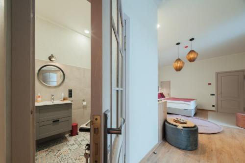 a bathroom with a sink and a bed in a room at Rozā Dāvids in Liepāja
