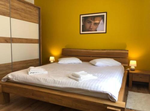 a bedroom with a bed with two towels on it at Holiday House Franov in Zadar
