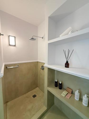 a bathroom with a shower and a sink at Ocean Caldera View Villa by Dalmyra Estate in Imerovigli