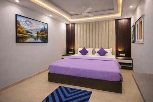 a bedroom with a large bed with purple sheets at The Nest Kashi in Varanasi