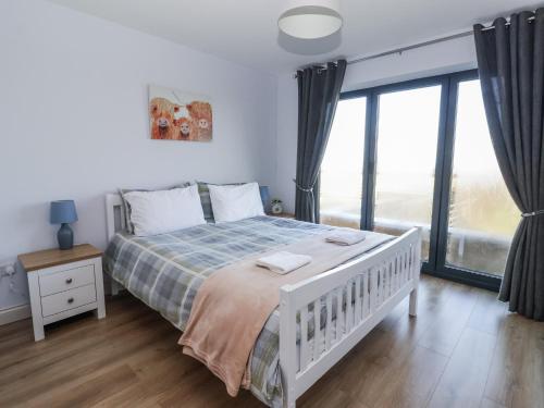 a bedroom with a white bed and a large window at Genesis in Richmond