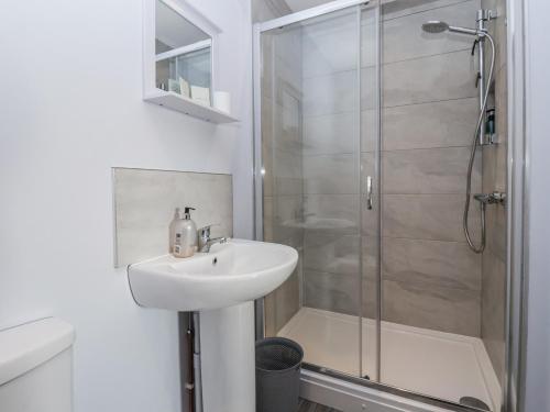 a white bathroom with a sink and a shower at Fleetwood in Richmond