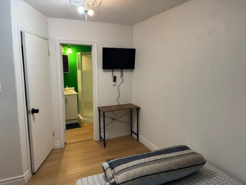 a living room with a tv on the wall at Private Room With Washroom Near Airport D14 in Mississauga