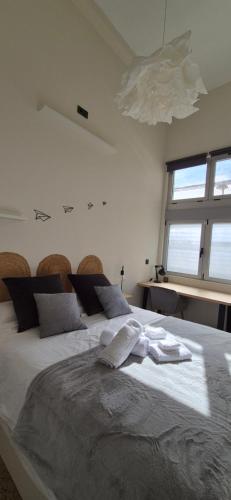 a bedroom with a large bed with white sheets and a window at A3 Valencia Ciudad cómodo Bajo Diseño hasta 6, wifi gratis in Valencia