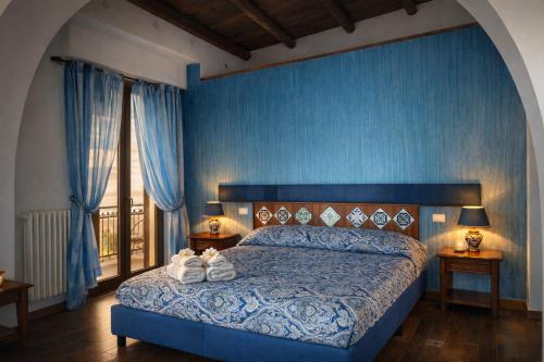 a bedroom with a bed with shoes on it at Centro Sicilia Rooms & Suites in Enna