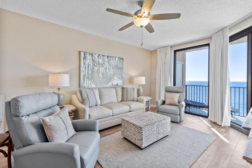 a living room with a couch and chairs and a ceiling fan at Phoenix X Unit 1512 in Orange Beach