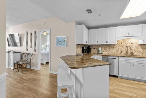 a kitchen with white cabinets and a kitchen island at Phoenix X Unit 1512 in Orange Beach