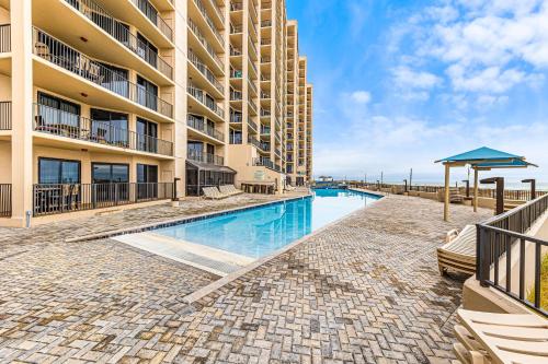 a swimming pool in front of a building at Phoenix X Unit 1512 in Orange Beach
