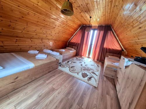 a room with two beds in a wooden cabin at tsilo in Batumi