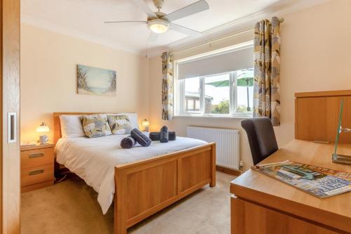 a bedroom with a bed with a dresser and a window at 3 Bed in Walcott oc-2135 in Walcott