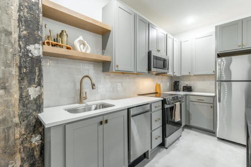 a kitchen with white cabinets and stainless steel appliances at Park Hotel 1BR Suite 410 in Chattanooga