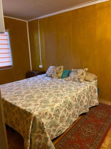 a bedroom with a bed with a blanket on it at Cabañas Donde Nancy in Hornillos