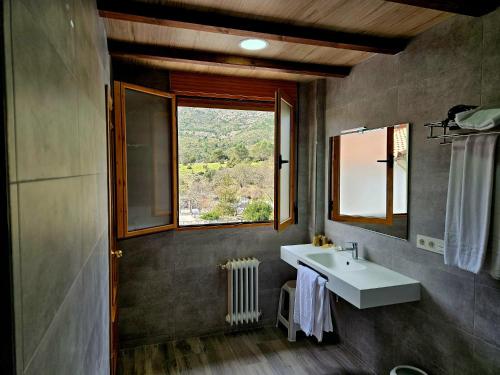 a bathroom with a sink and a window at Hotel Rural Montaña de Cazorla in Arroyo Frio