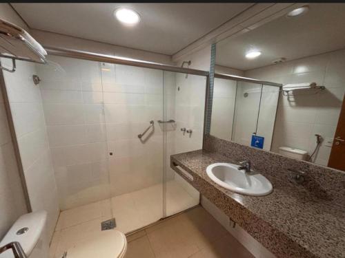a bathroom with a shower and a sink and a toilet at Flat hotel Blue tree no adrianopolis Até 4 pessoas in Manaus