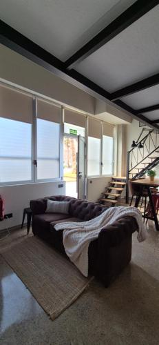 a living room with a couch in a room with windows at Nuevo Apartamento Industrial Deco Valencia Capital in Valencia
