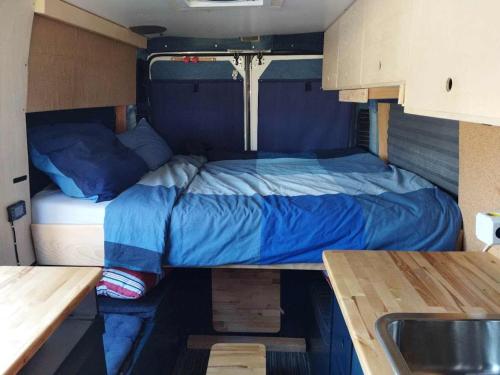 a bed in the back of a rv at Kampervan in Vrhovine