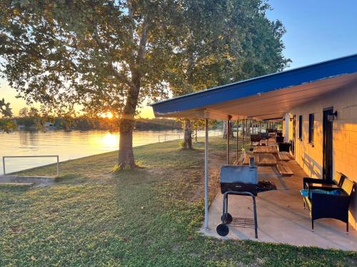 a pavilion with a table and chairs next to a lake at Oasis Lake Buchanan in Bluffton