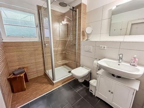 a bathroom with a toilet and a sink and a shower at Ferienwohnung W18 0 N in Graal-Müritz