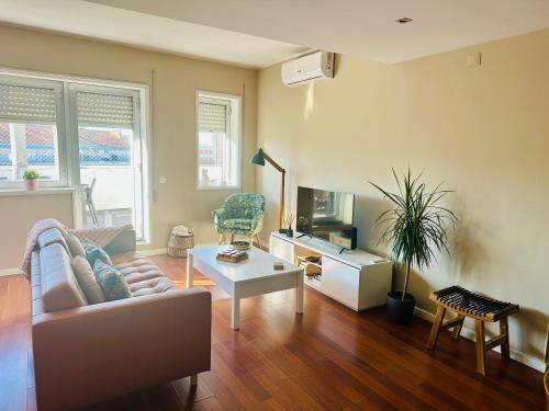 a living room with a couch and a table at Premium Quental House - T3 Renovado com magnifico Terraço in Porto