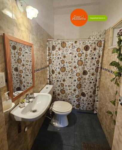 a bathroom with a toilet and a sink and a shower at Casa Mandarina San Luis in La Punta