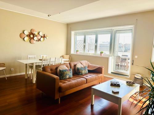 a living room with a couch and a table at Premium Quental House - T3 Renovado com magnifico Terraço in Porto