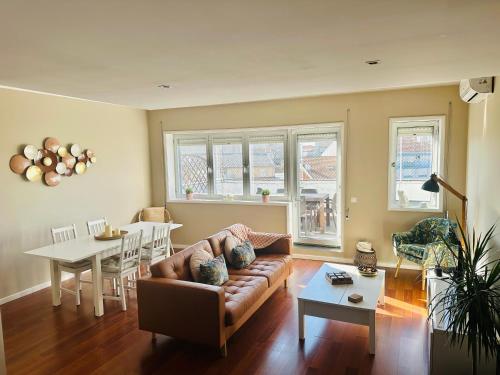 a living room with a couch and a table at Premium Quental House - T3 Renovado com magnifico Terraço in Porto