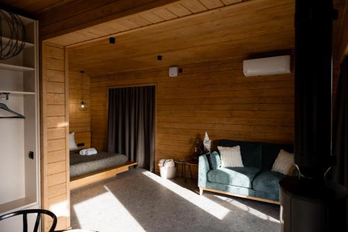 a room with a couch in a wooden room at Shepit space in Slavske