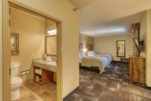 a hotel room with a bed and a bathroom at The Lodge at Deadwood in Deadwood