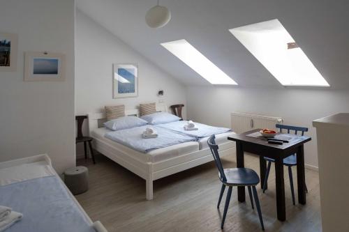 a bedroom with a bed and a table with a chair at Pension Katzensprung in Passau
