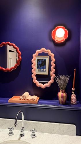 a bathroom with two mirrors and a sink at Boutique Hôtel Le Clos Huguerie - Bordeaux Centre in Bordeaux