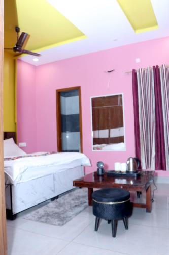 a room with a bed and a table in it at The City View- Hotel and Restaurant in Bhiwāni