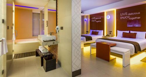 a hotel room with two beds and a bathroom at V Boutique Viaducto in Mexico City