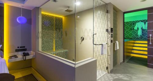 a bathroom with a shower with a glass door at V Boutique Viaducto in Mexico City