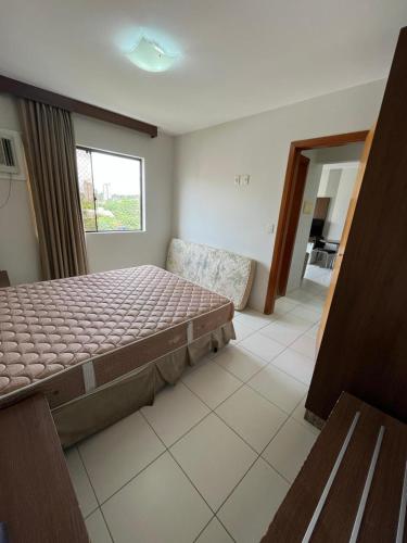 a bedroom with a large bed and a window at Privê Boulevard Suíte Hotel - 706 - Caldas Novas GO in Caldas Novas