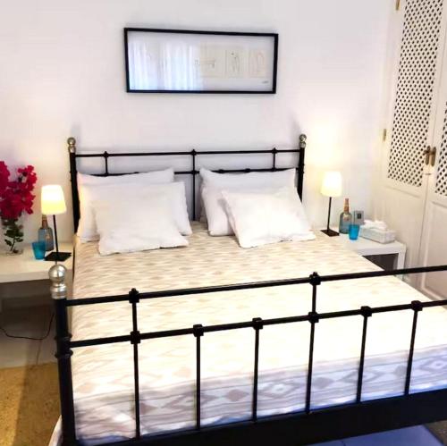 a bedroom with a black bed with two white pillows at Casa CedenoXavi in Santa Ponsa