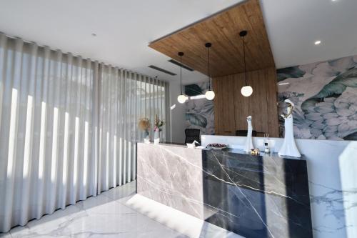 a bathroom with a counter and a wall of windows at Le perle del golfo Scafati in Scafati