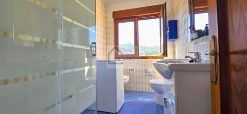 a bathroom with a sink and a toilet at Villa Trinamar - Casa rural en Valdes cerca de Luarca in Carcedo