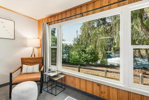 a room with a window with a chair and a table at Pet Friendly Riverside Studio in Downtown Bend in Bend